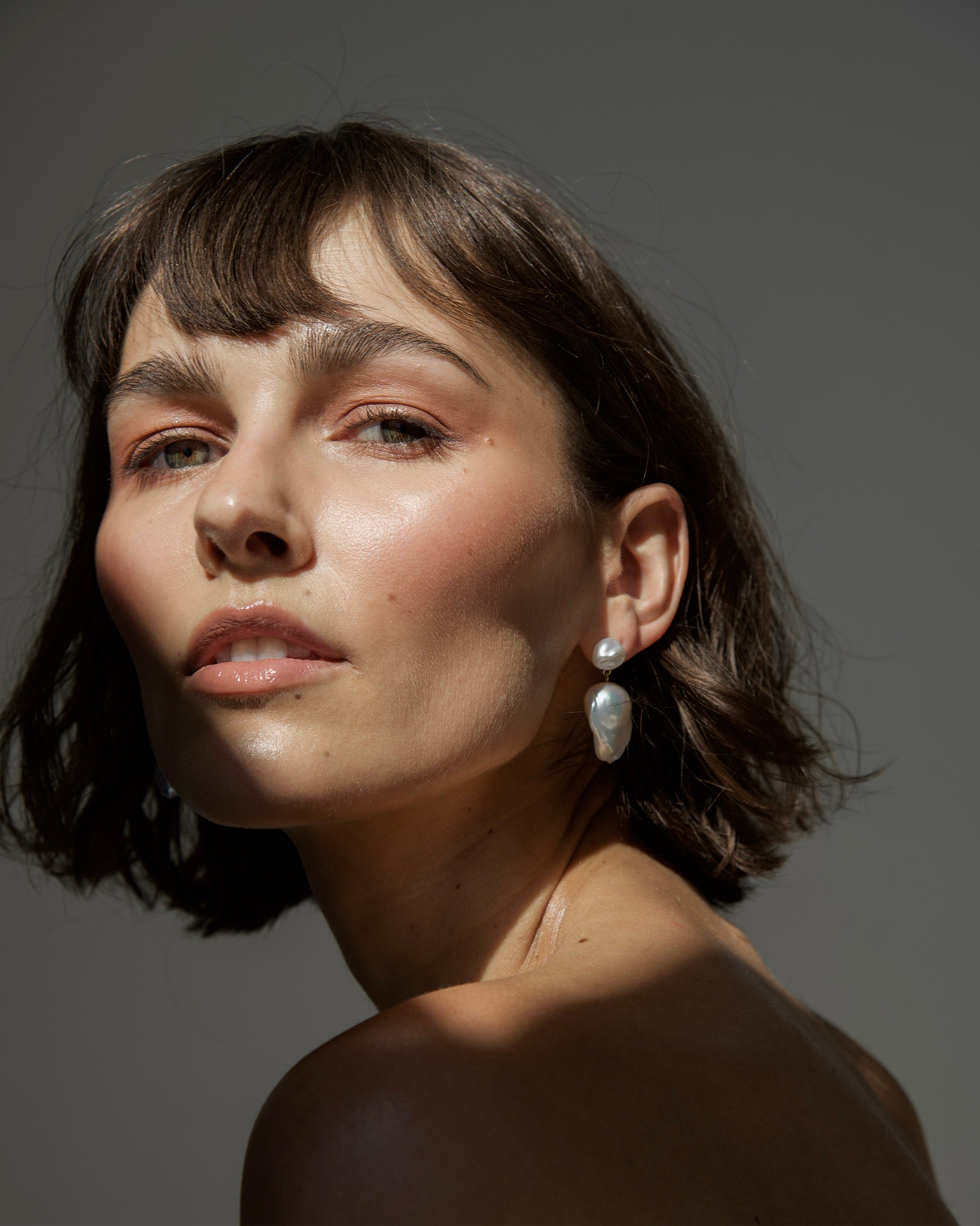 Bare Baroque Pearl Earrings styled on model – understated statement jewelry that highlights imperfection and individuality by monái