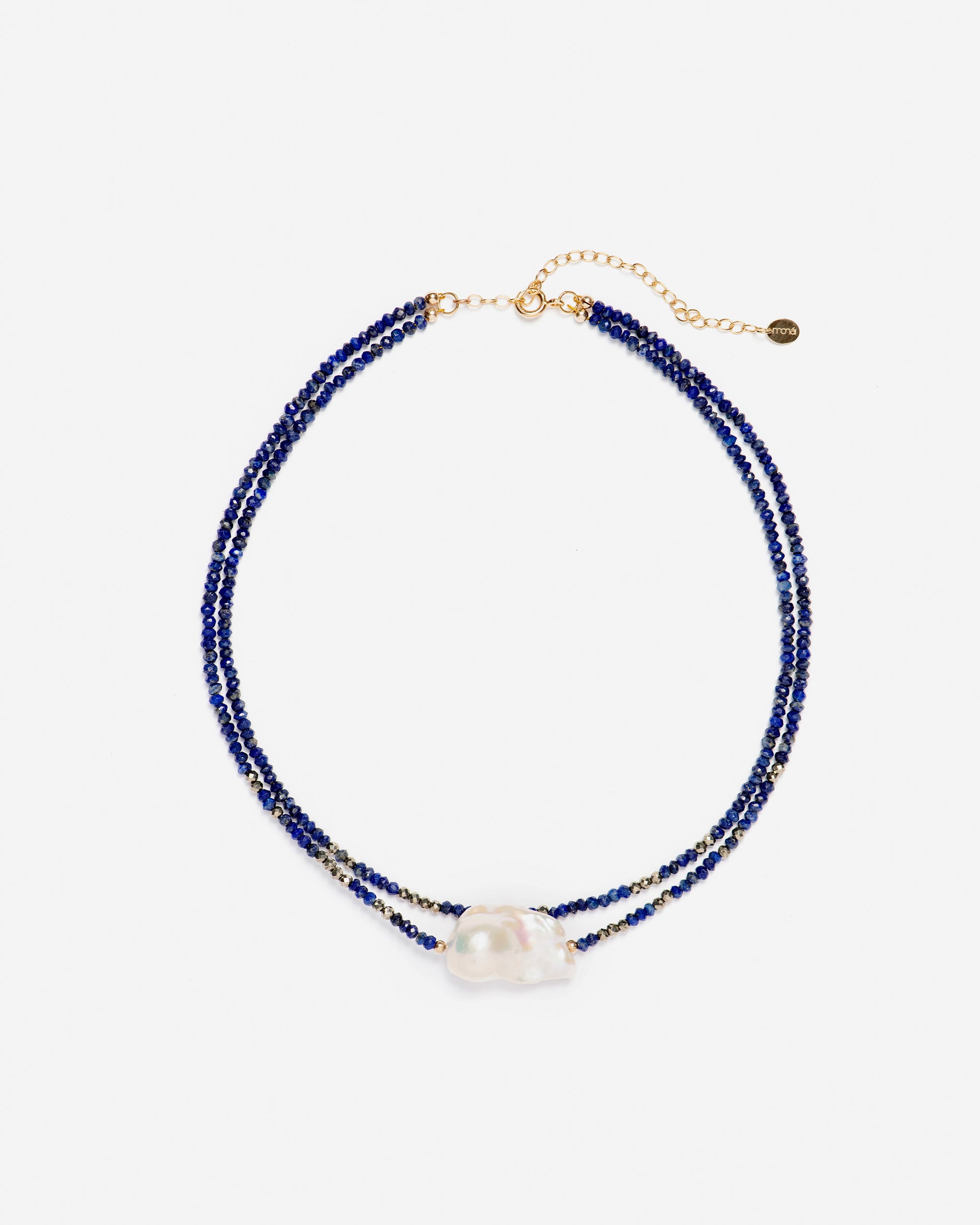 monái baroque pearl and lapis lazuli necklace laid flat – minimalist handcrafted design featuring deep blue stones and uniquely shaped pearls