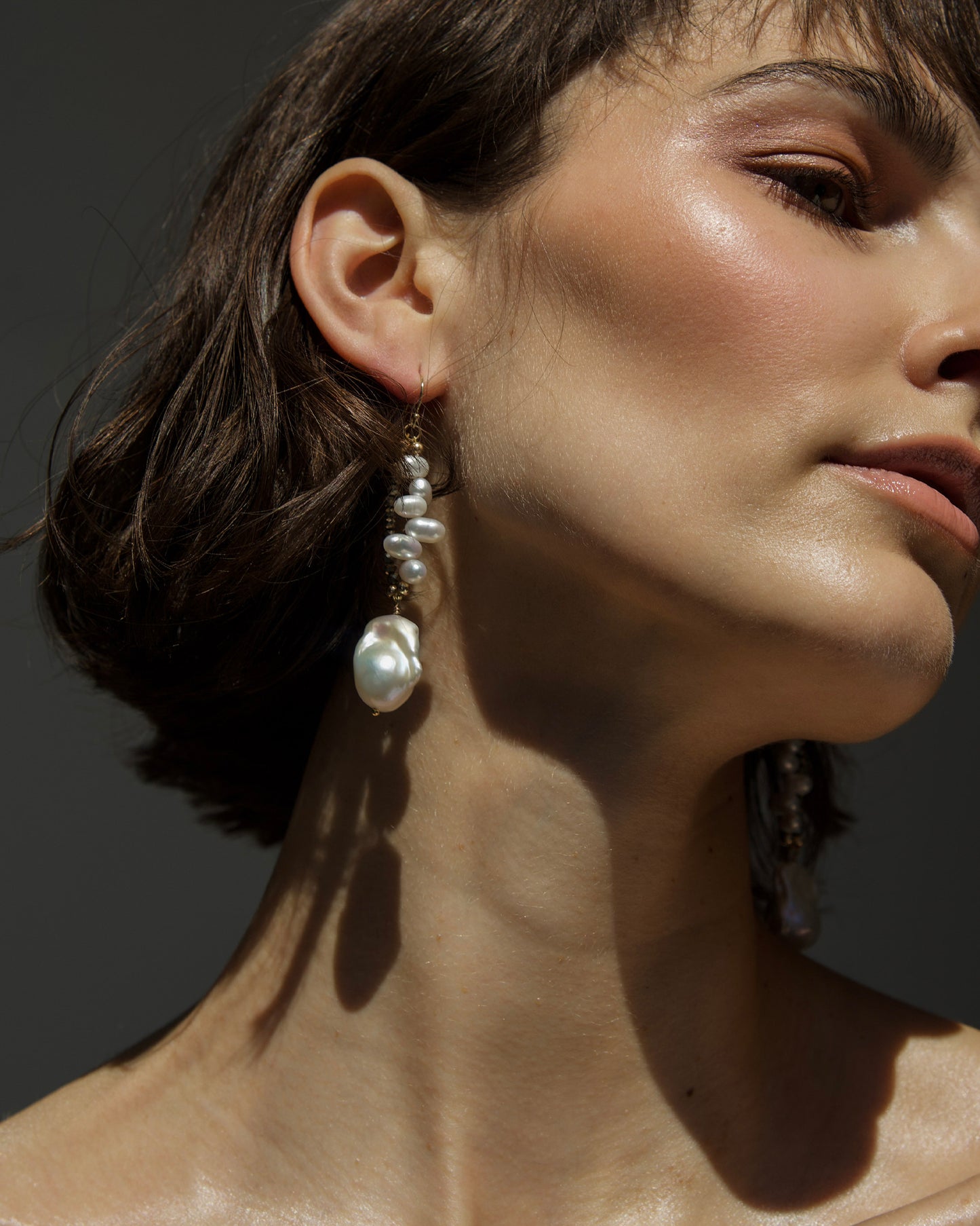 close-up of monái baroque pearl pyrite earrings showcasing AAA+ quality baroque pearls paired with hand-cut pyrite gemstones – a harmonious blend of organic form and metallic shimmer