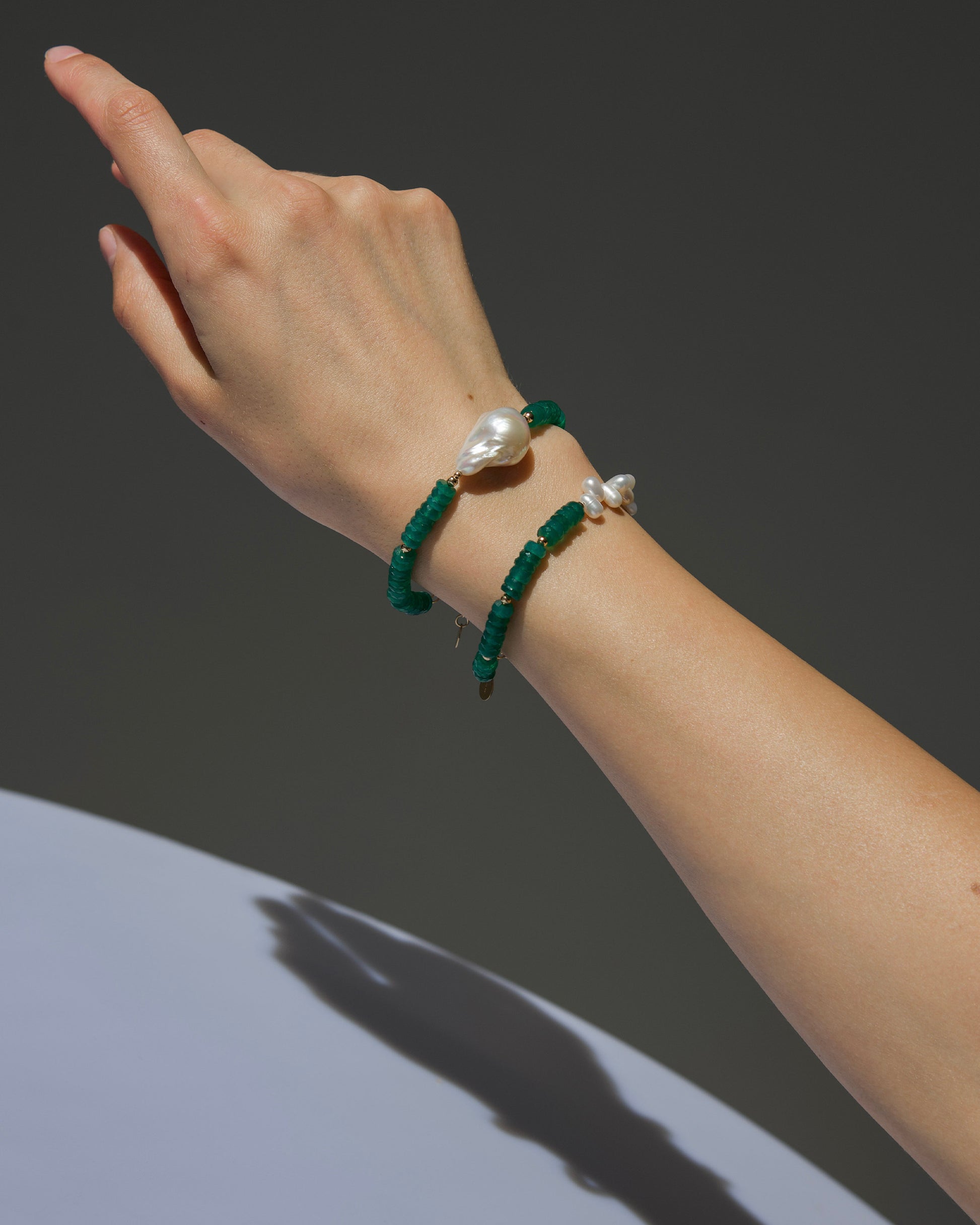 monái green onyx asymmetrical bracelet stacked with green onyx accent pearl bracelet – layered styling that blends structure with organic rhythm