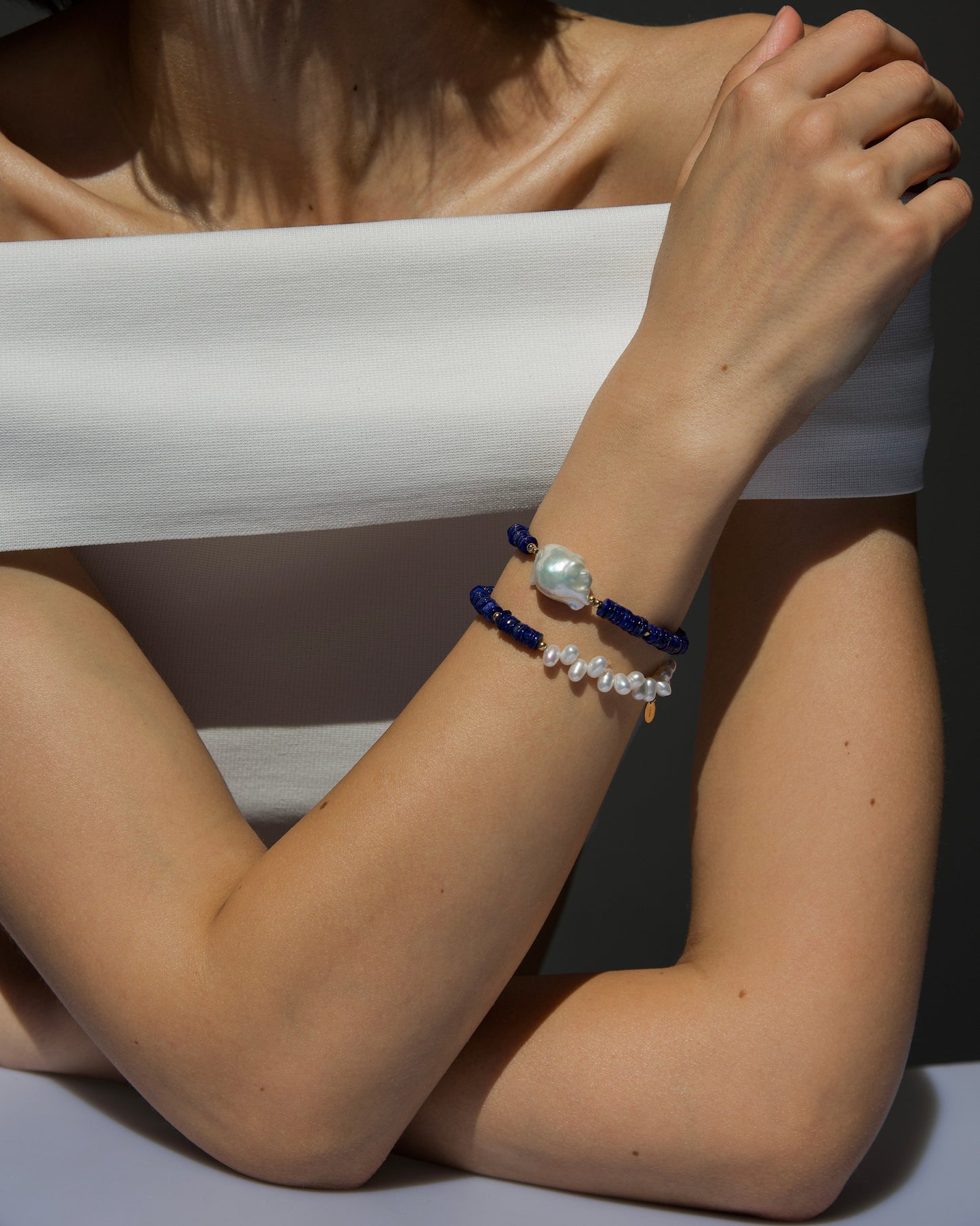 monái lapis lazuli asymmetric bracelet styled with lapis lazuli accent pearl bracelet – layered look highlighting deep blue gemstones, luminous pearls, and gold-filled details for a bold yet elegant wrist stack