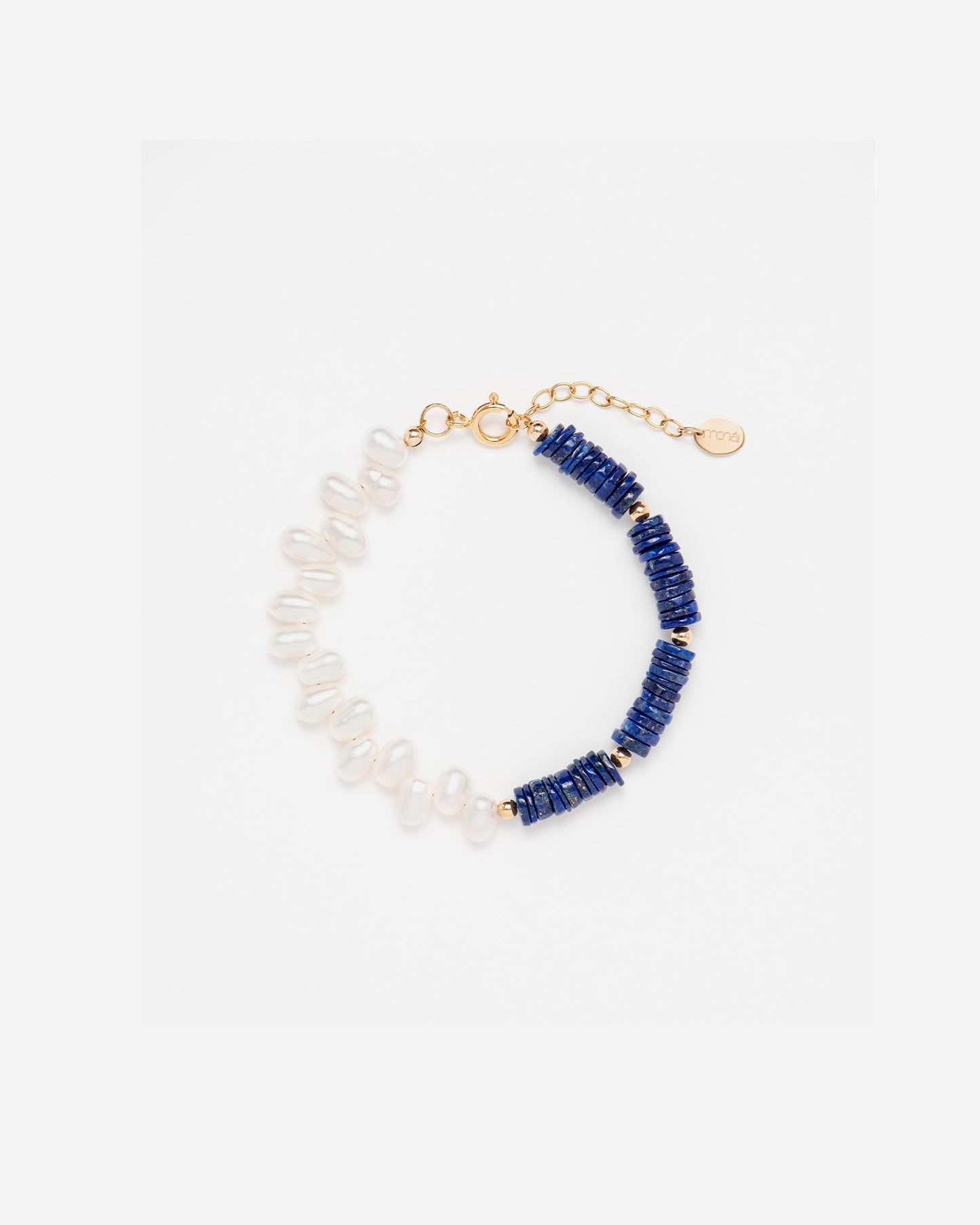 monái lapis lazuli asymmetric bracelet laid flat – handcrafted design featuring deep blue lapis lazuli, luminous baroque pearl, and 14K gold-filled hardware