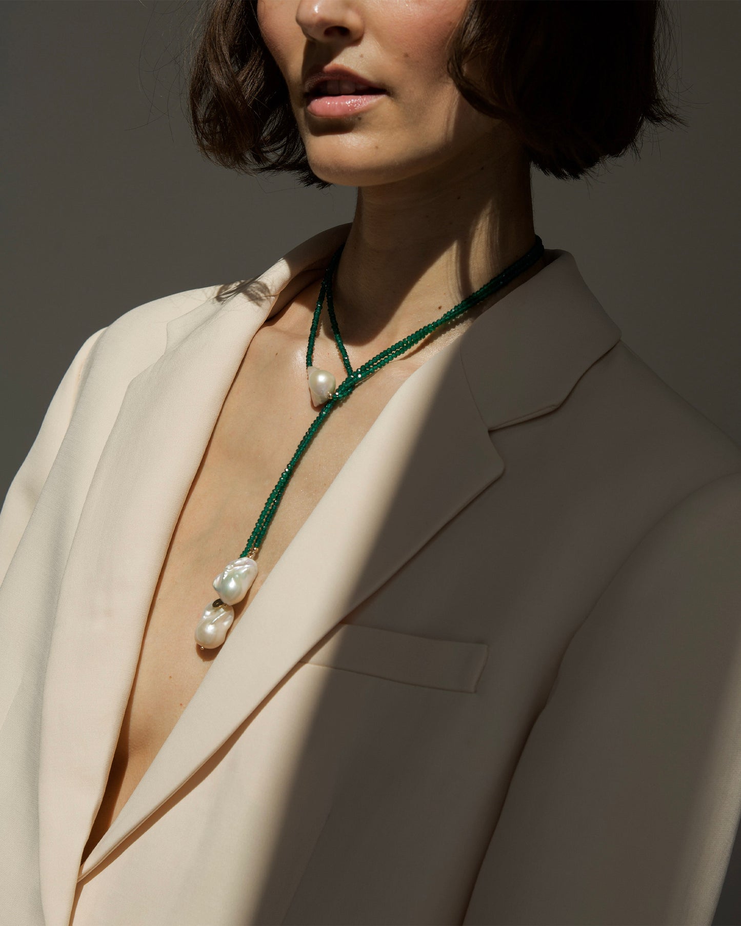 monái necklace with three baroque pearls and green onyx styled on neck – statement piece that balances softness and strength