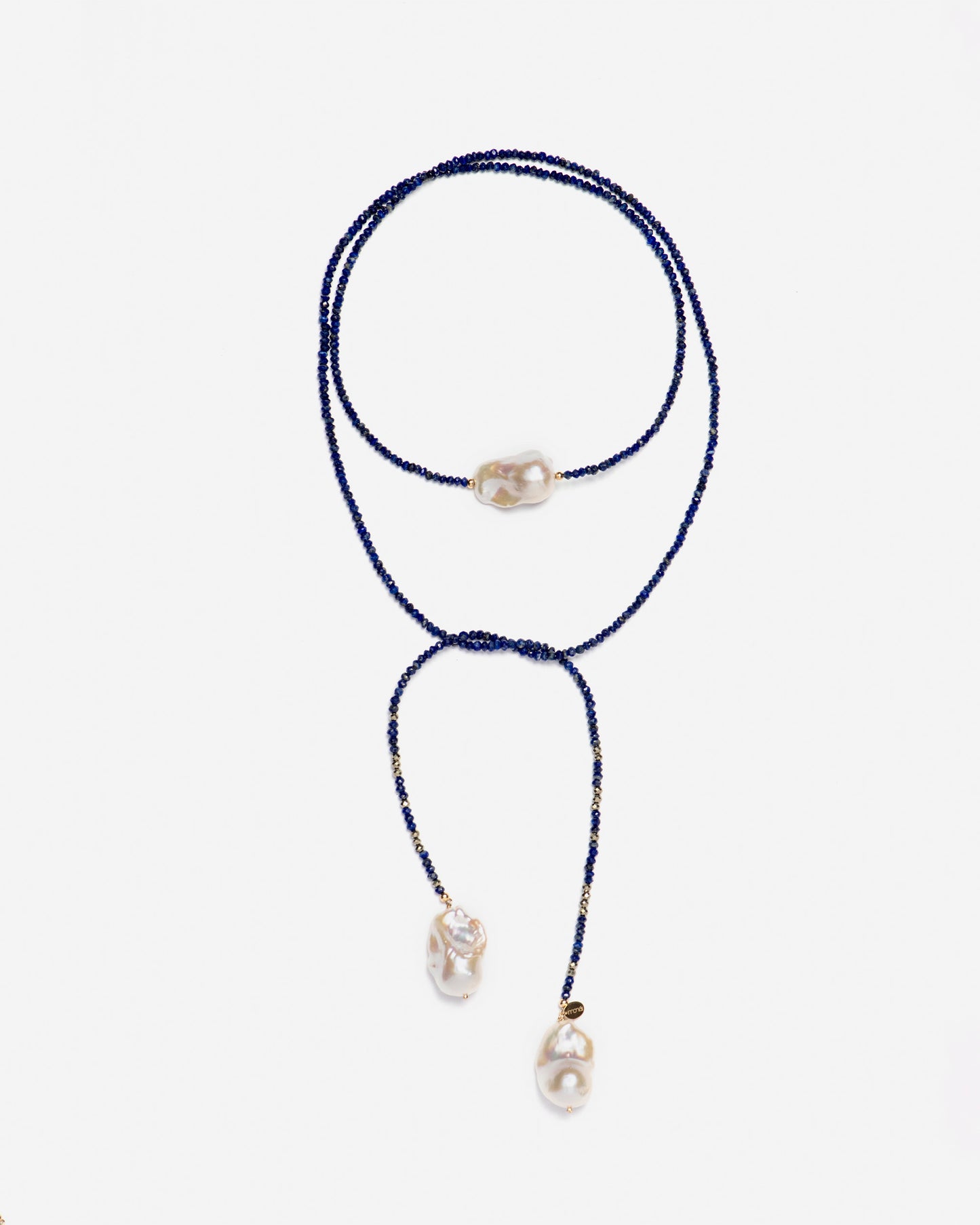 monái long baroque pearl lapis lazuli necklace knotted at the front – showcasing the piece's adaptability and bold design