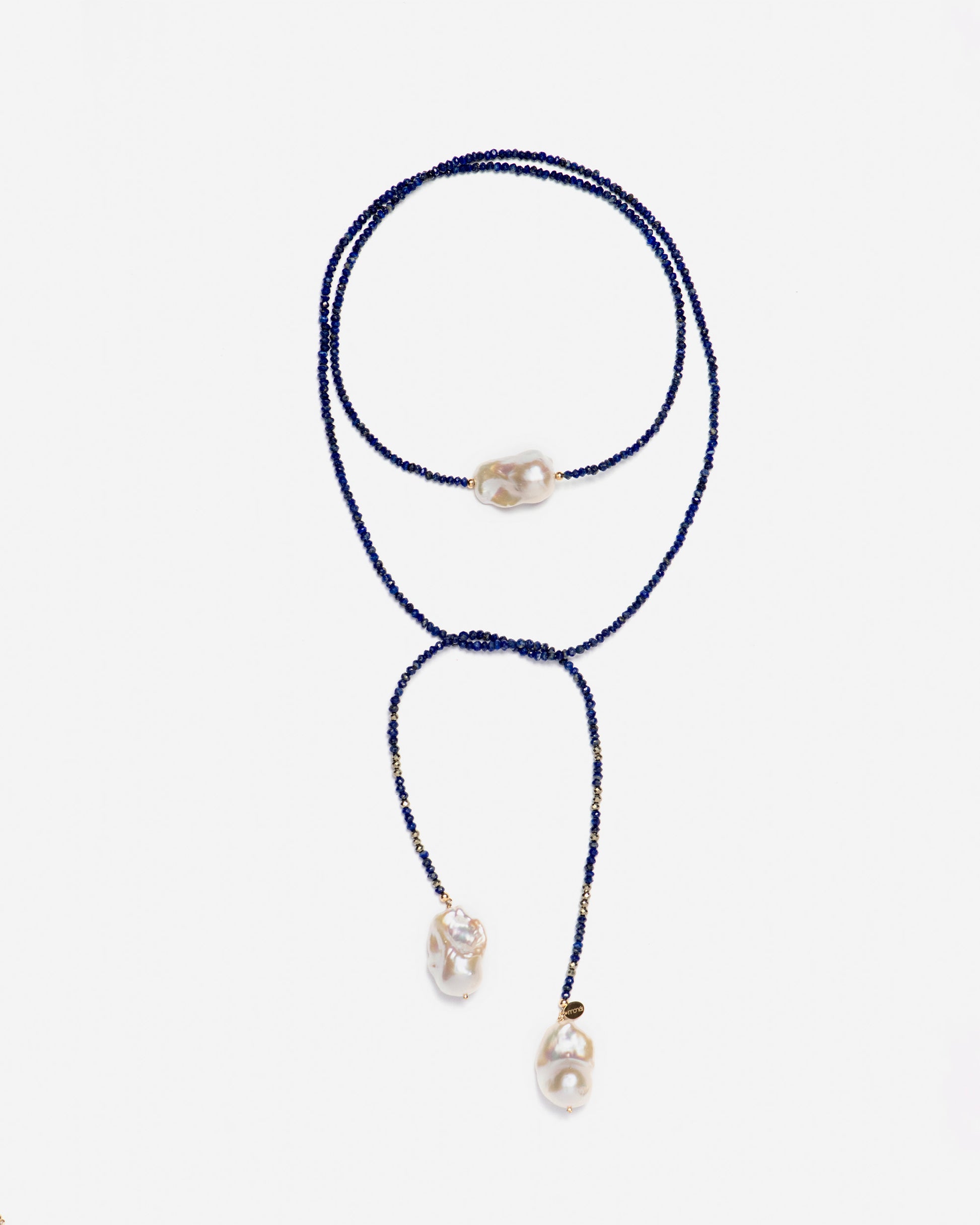 monái long baroque pearl lapis lazuli necklace knotted at the front – showcasing the piece's adaptability and bold design
