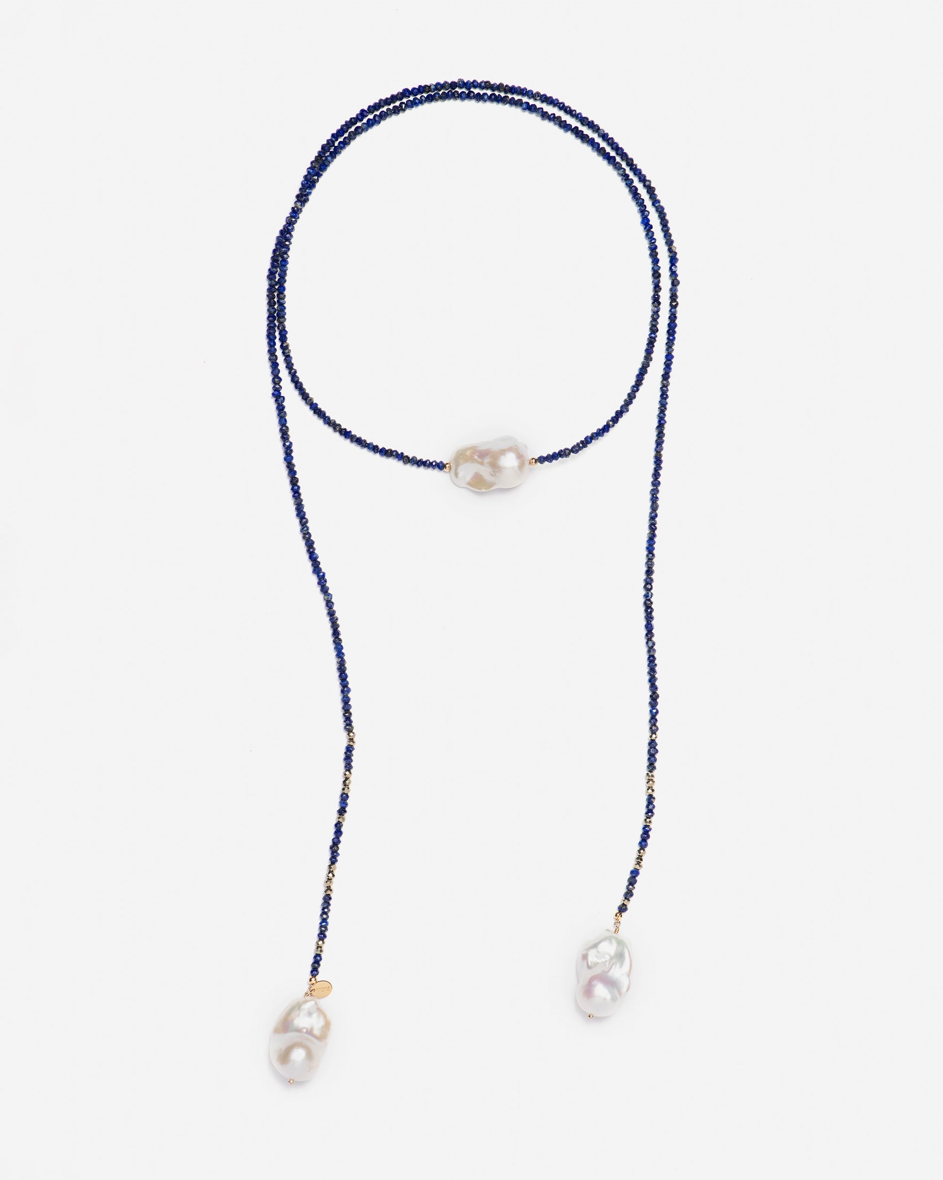 monái long baroque pearl lapis lazuli necklace laid flat – handcrafted design featuring deep blue lapis lazuli, golden pyrite, and unique baroque pearls