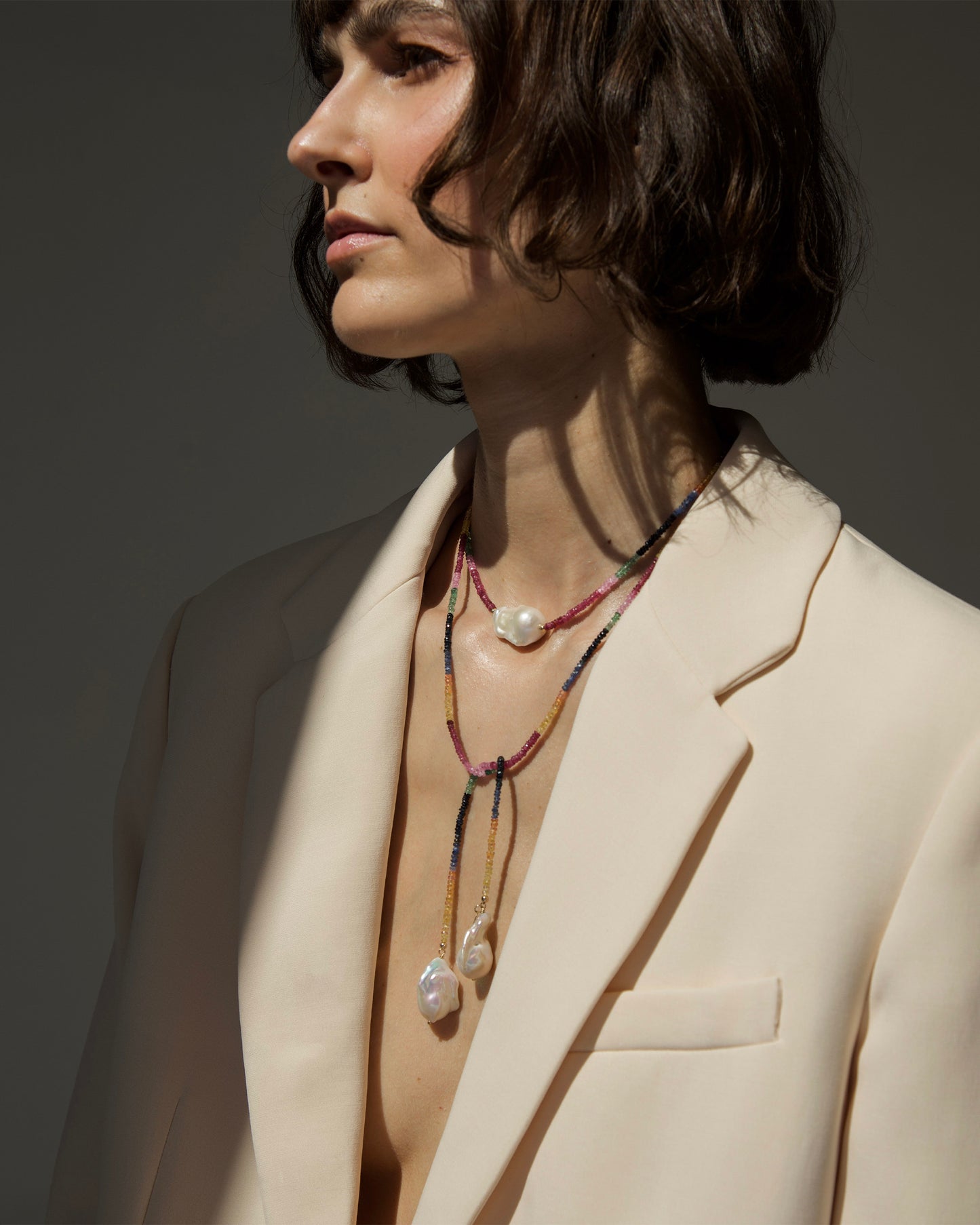 monái long baroque pearl rainbow necklace fastened as a loop on model – versatile styling highlighting the interplay of natural gemstones and pearls