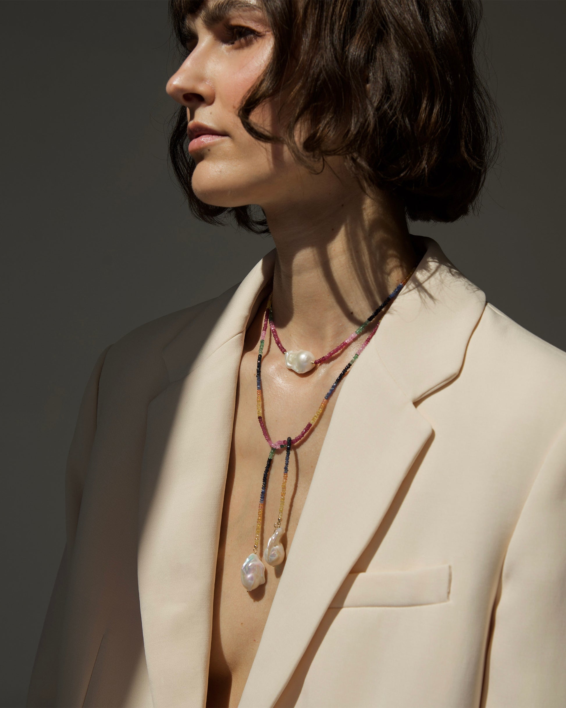 monái long baroque pearl rainbow necklace fastened as a loop on model – versatile styling highlighting the interplay of natural gemstones and pearls