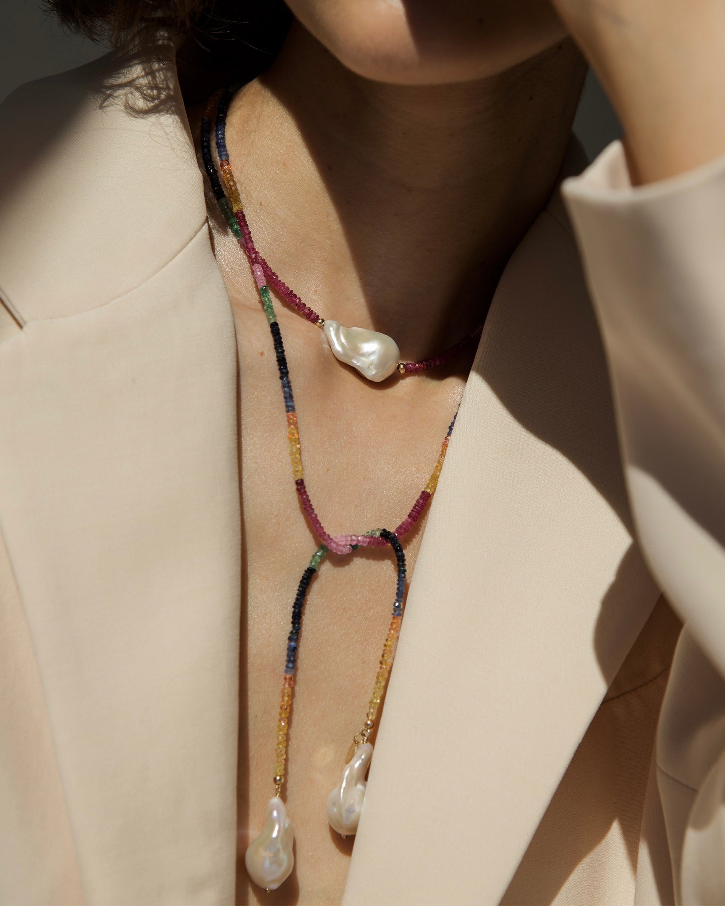 monái long baroque pearl rainbow necklace styled in a knot on model – showcasing the piece's adaptability and bold design