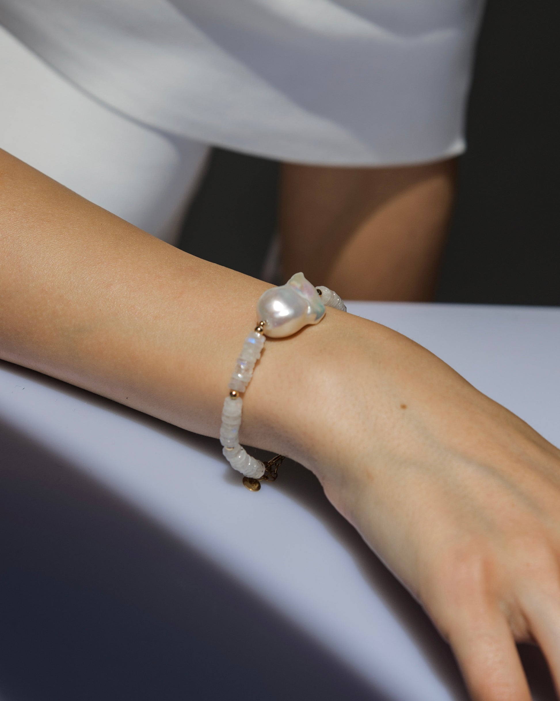 close-up of monái bracelet showcasing AAA+ quality baroque pearls paired with hand-cut rainbow moonstone gemstones – a harmonious blend of organic form and ethereal shimmer