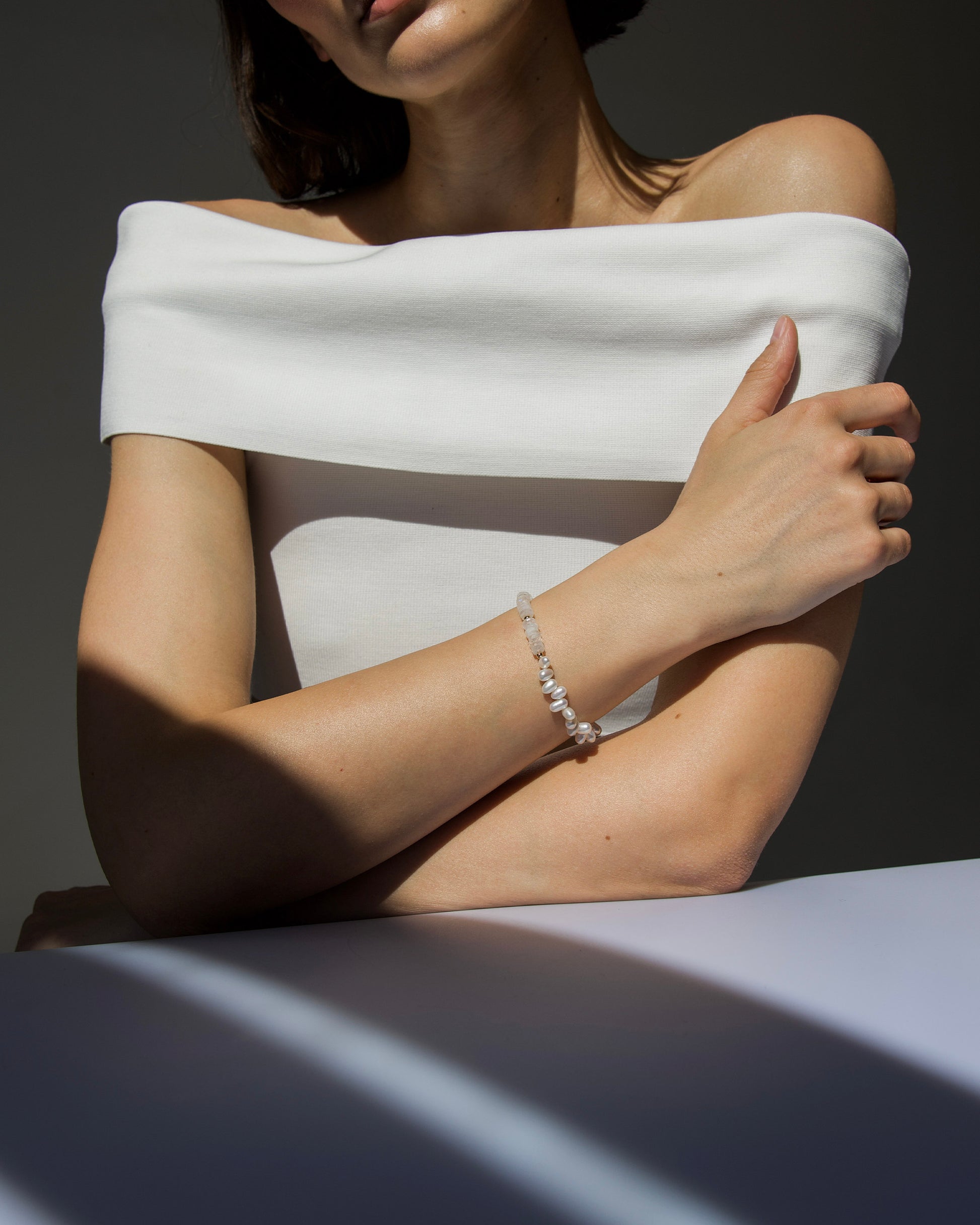 monái rainbow moonstone asymmetrical bracelet shown on model as part of a complete look – timeless statement piece with organic, natural charm