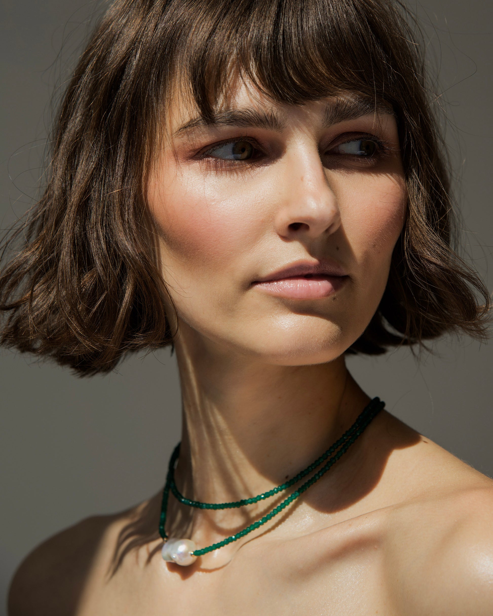 monái baroque pearl and green onyx necklace styled on neckline – refined everyday luxury with natural individuality