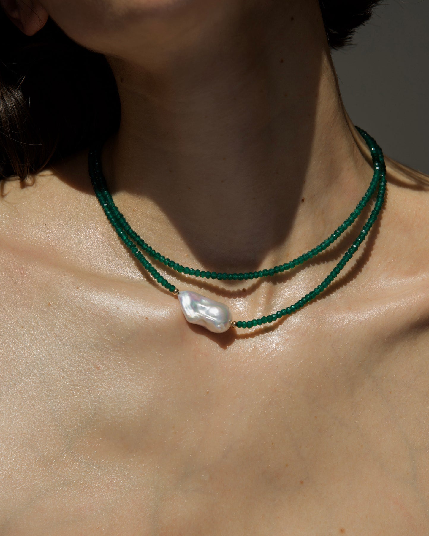 detail of monái necklace with baroque pearls and green onyx – a delicate balance of organic form and bold color