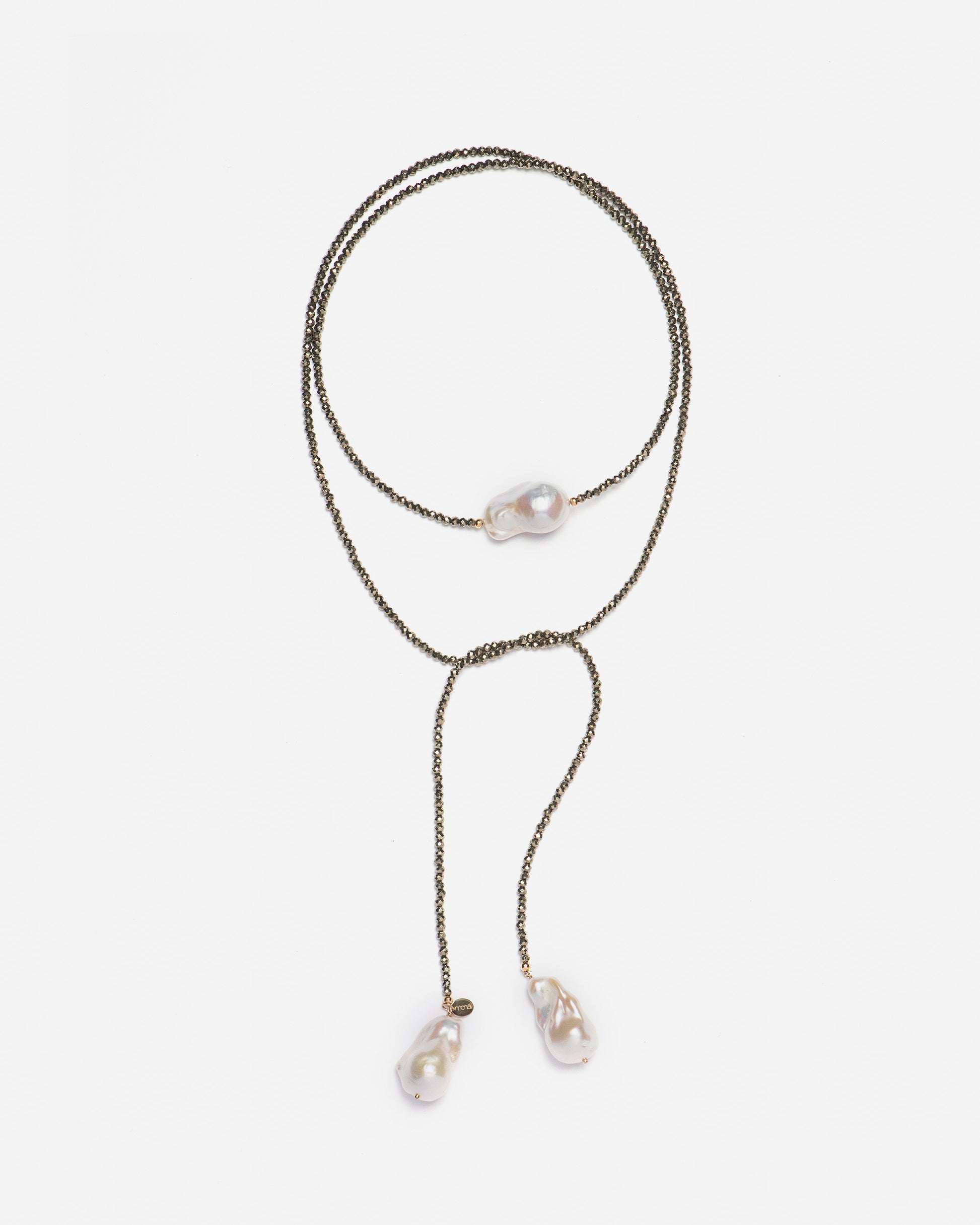 close-up of monái long baroque pearl pyrite necklace showcasing AAA+ quality baroque pearls paired with hand-cut pyrite gemstones – a harmonious blend of organic form and metallic shimmer