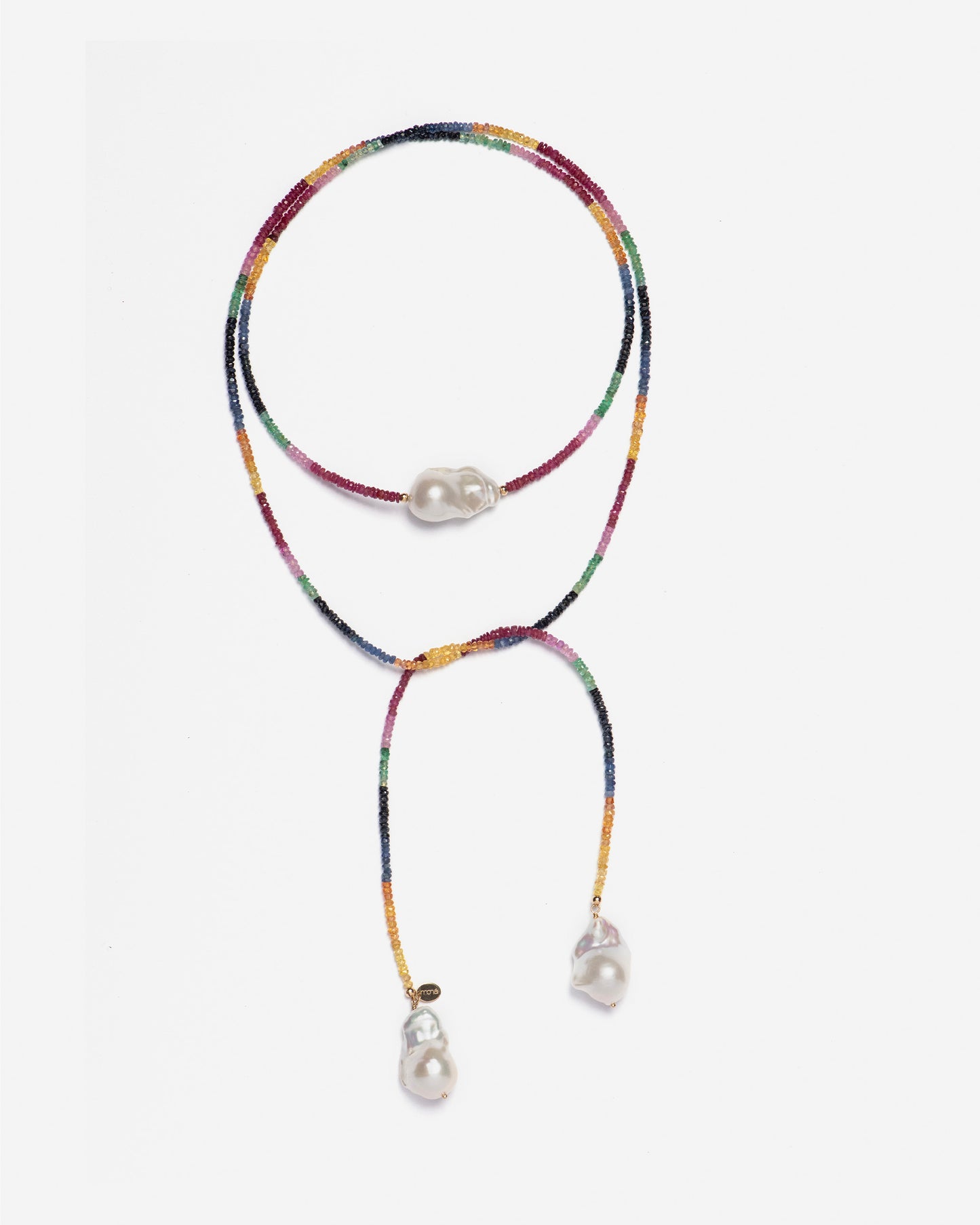 close-up of monái necklace showcasing AAA+ quality baroque pearls paired with hand-cut ruby, emerald, blue and yellow sapphire gemstones – a harmonious blend of organic form and vibrant color
