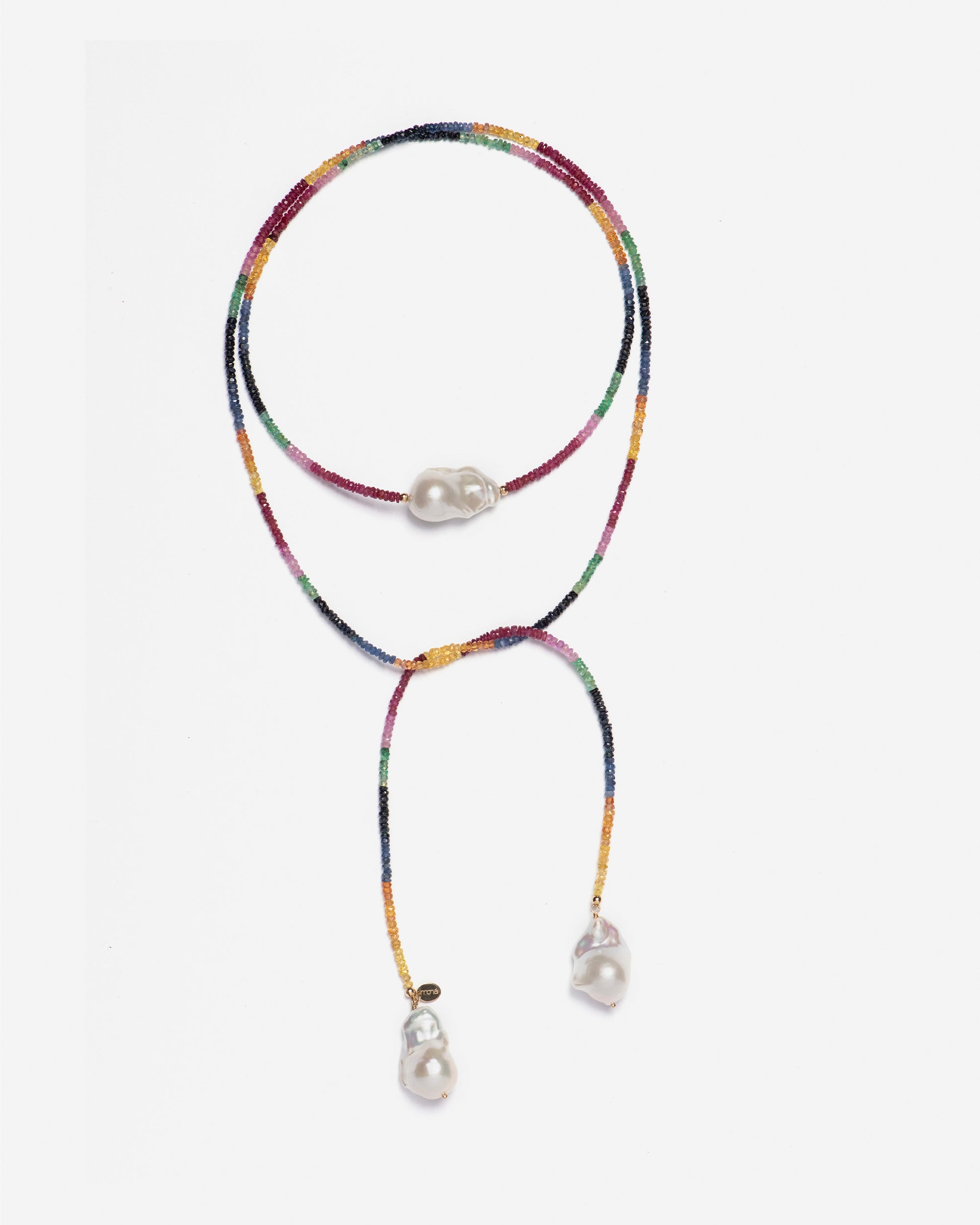 close-up of monái necklace showcasing AAA+ quality baroque pearls paired with hand-cut ruby, emerald, blue and yellow sapphire gemstones – a harmonious blend of organic form and vibrant color